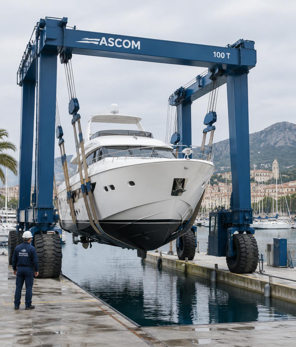 Travel-lift crane hauling a yacht out of the water at a marina