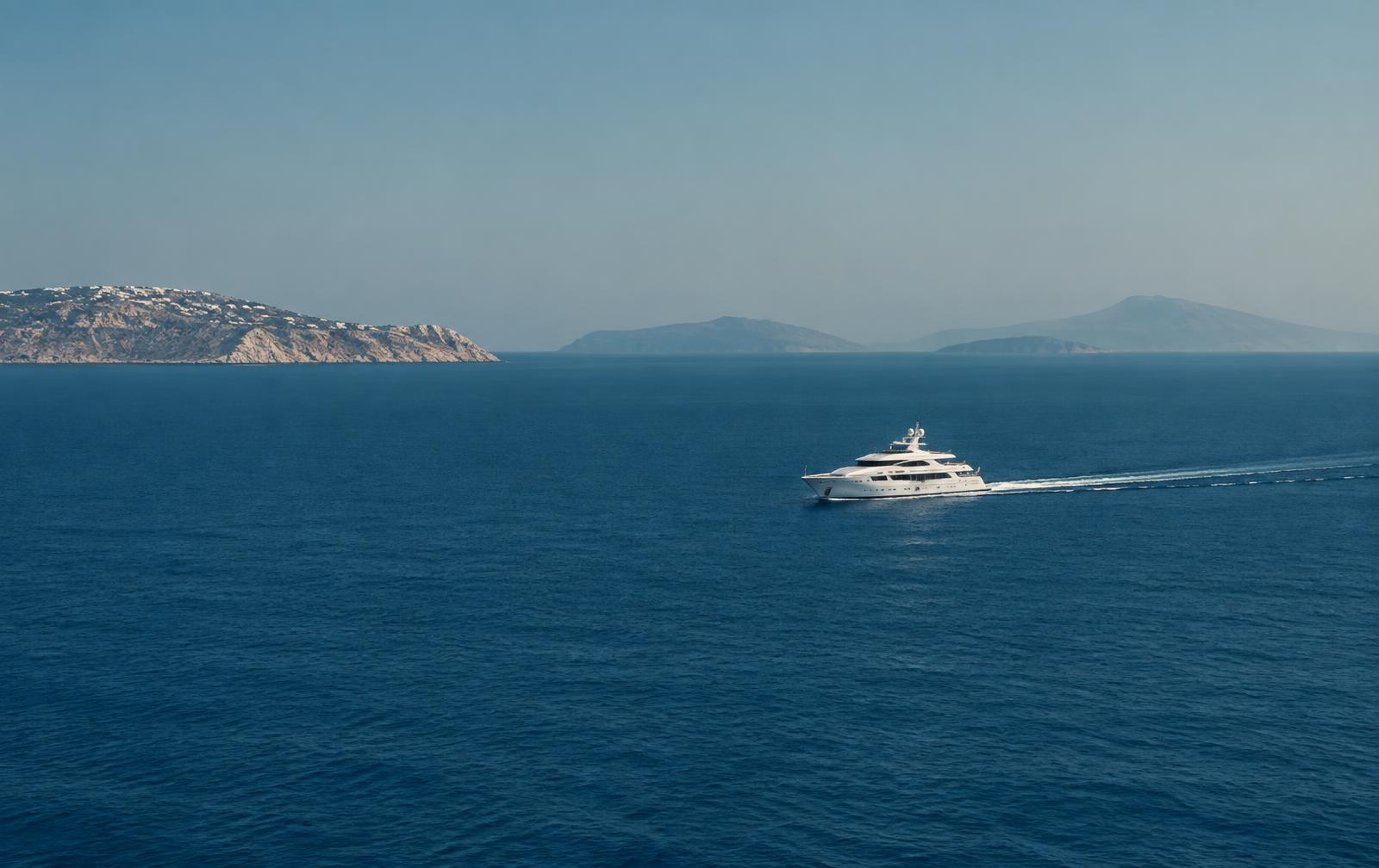 White yacht cruising on open Aegean water near Greek islands